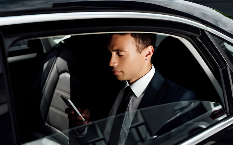 Professional chauffeur portrait inside a luxury vehicle
