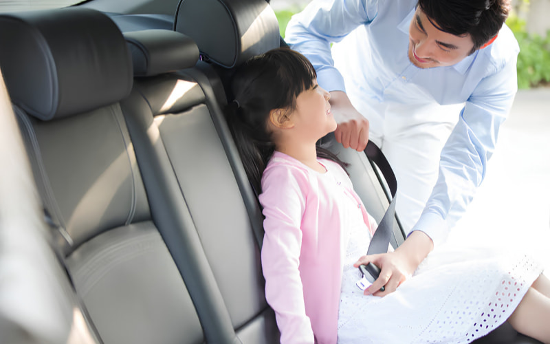 Passenger relaxing in rear seat of a luxury chauffeur car